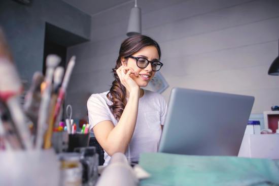 Woman smiling at her laptop