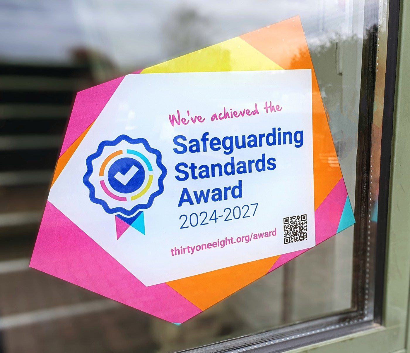 Thirtyone:eight logo and rosette with the words Safeguarding Standards Award