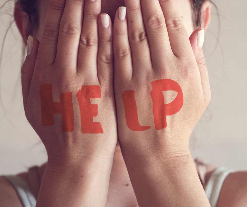 Young woman covering her face with her hands.