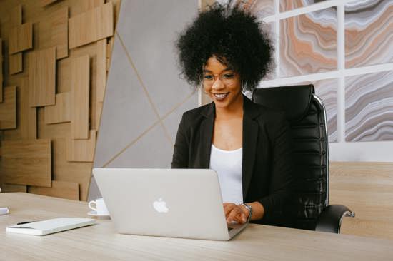 Woman smiling at her laptop