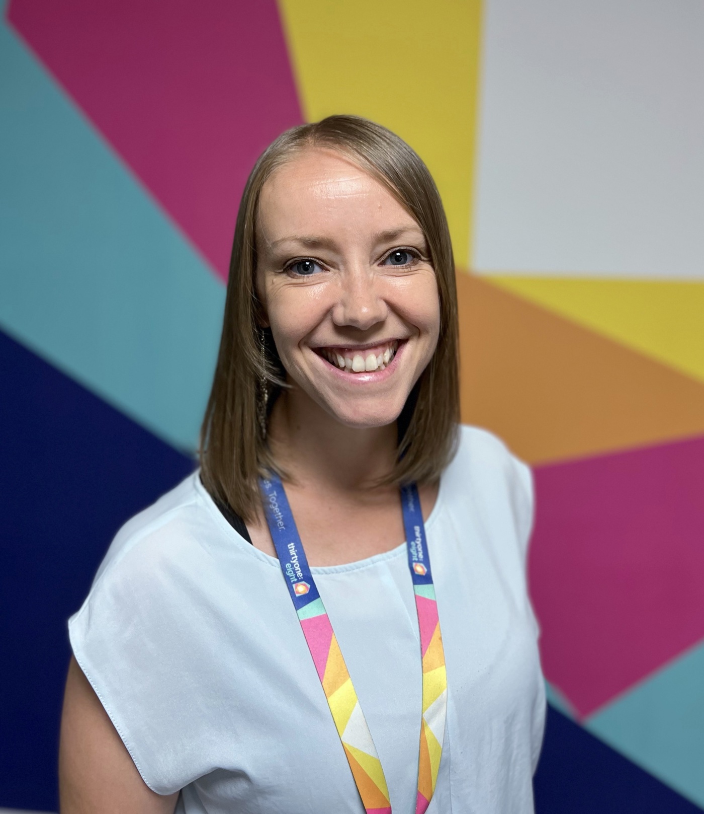 Headshot of Sarah McBride in front of the Thirtyone:eight logo