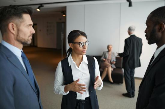 Image depicting three board members in conversation