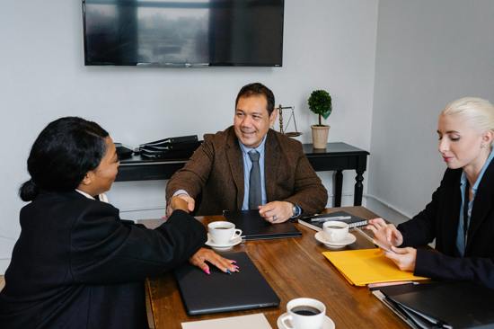 Image depicting a board meeting with three members