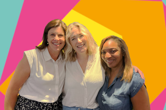 Image of the Thirtyone:eight membership team standing in front of the Thirtyone:eight logo