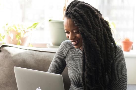 Woman smiling at her laptop